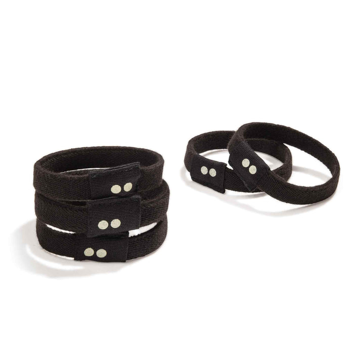 Two sets of KOOSHOO Organic Hair Ties in black fabric, with snap buttons, are shown on a white background—one stacked in three layers, the other in two. These plastic-free hair ties offer a zero-waste accessory option.