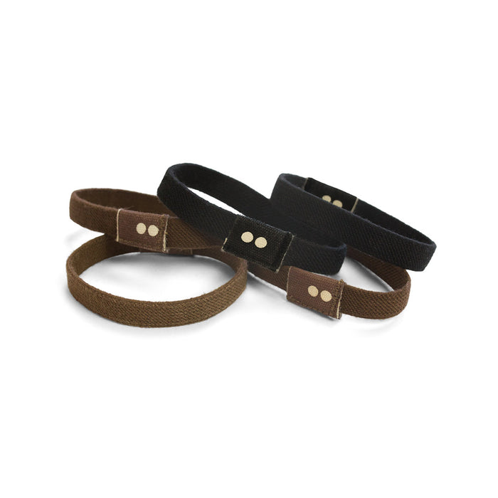 The KOOSHOO Organic Hair Ties, crafted with care and Fair Trade-certified, come in a set of four black and brown woven bands, each with a small rectangular clasp featuring two dots. These stylish accessories provide both ethical appeal and timeless elegance on a plain white background.