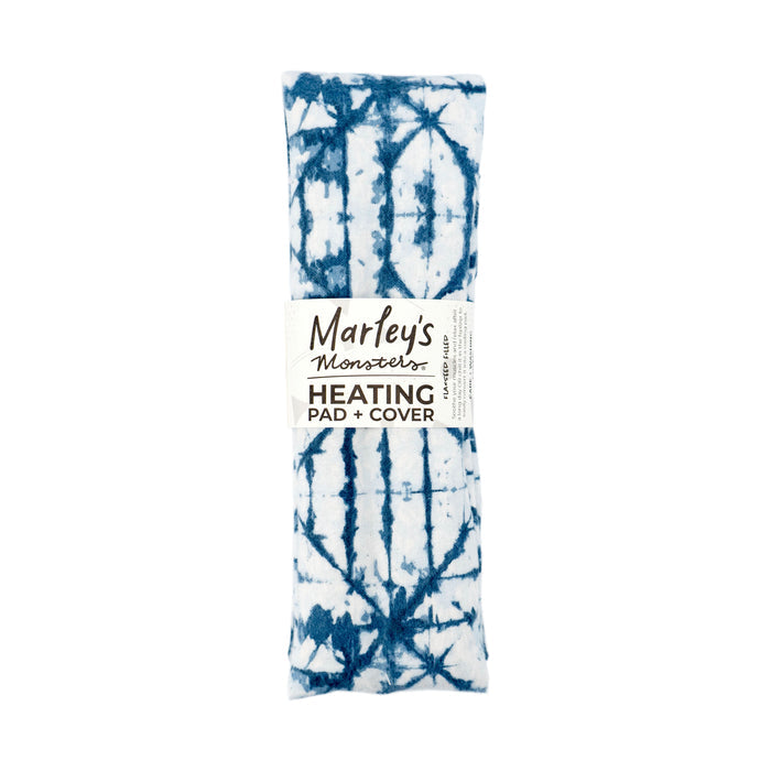 A blue and white tie-dye rectangular heating pad, labeled Marleys Monsters Flax Seed Heating Pad with Cover, is crafted to be flaxseed-filled for optimal comfort and is entirely plastic-free.