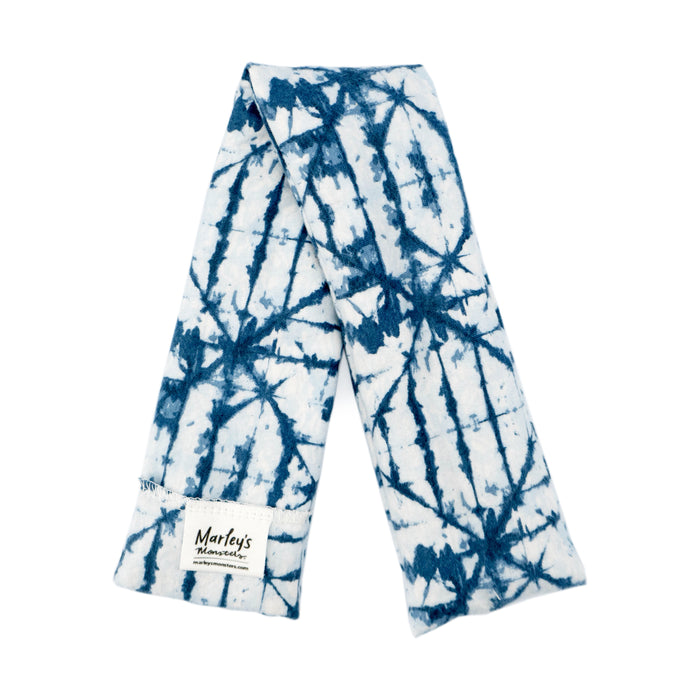 A scarf with a blue and white tie-dye pattern, made from soft cotton flannel, includes a small label marked Marleys Monsters on one end.