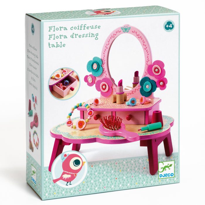 The Flora Dressing Table Play Set by DJECO, crafted from 100% FSC® Certified Wood, includes a mirror and playful accessories like flowers, a brush, and makeup items. The box features an illustration of the assembled set and is ideal for imaginative play for ages 4 and up.