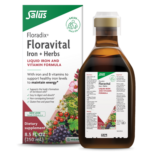 A bottle and box of Floradixs Floravital® Iron & Herbs Yeast-Free supplement, enhanced with essential B Vitamins. The gluten-free packaging features product information and colorful fruit and herb illustrations, while the bottle displays a detailed label.