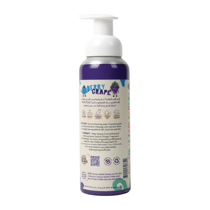 The Pacha Soap Co. Foaming 2-in-1 Shampoo and Body Wash features a purple and white bottle with a cartoon grape character and Berry Grape text. It offers a gentle bath experience with non-toxic ingredients, usage instructions, and a white pump dispenser for an enjoyable cleanse.