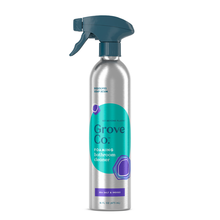 The Grove Co. Foaming Bathroom Cleaner, in an 18 fl oz (475 mL) recyclable aluminum spray bottle with a teal and purple label and blue nozzle, features a sea salt and neroli scent that enhances the multi-purpose formula to effectively dissolve soap scum.