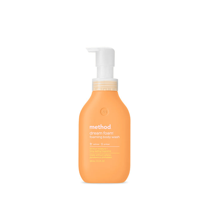An orange bottle of method Foaming Body Wash features a calming lavender and amber scent. Made from recycled plastic, it has a white pump and detailing in white text. The cruelty-free formula is showcased against a clean white background.