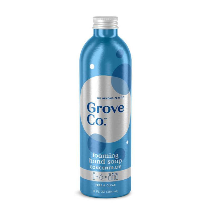 The Grove Co. Foaming Hand Soap Refill in a blue metallic 12 fl oz bottle highlights sustainable packaging with Go Beyond Plastic and Free & Clear text, featuring white/dark blue circles, and is made from plant-based ingredients for an eco-friendly and effective clean.