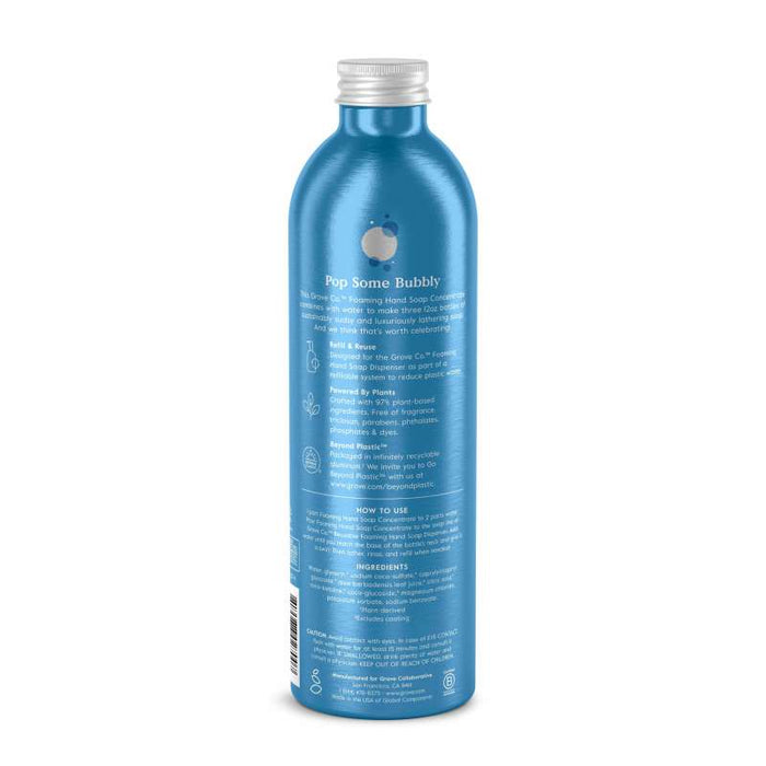 The Foaming Hand Soap Refill from Grove Co. is housed in a blue cylindrical bottle with a silver cap featuring Pop Some Bubbly. It highlights plant-based ingredients, eco-friendly icons, soap contents, usage instructions, and sustainable packaging details on the label.