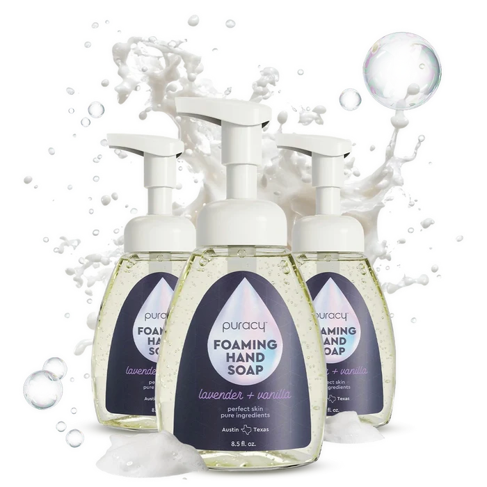 Three bottles of Foaming Hand Soap with plant-based ingredients and lavender, surrounded by soap bubbles.