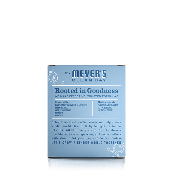 A blue Mrs. Meyers product box with white text displays Rooted in Goodness, featuring plant-derived ingredients such as olive oil and aloe vera. Highlighting garden values, Foaming Hand Wash Concentrate Refills offer natural cleaning agents in refillable bottles.