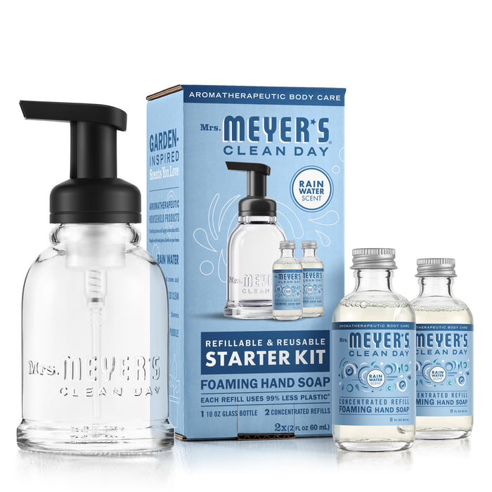 Image of Mrs. Meyers Foaming Hand Wash Concentrate Starter Set, including a refillable dispenser and two Rain Water scented concentrates. The packaging features a blue and white design with detailed product information.