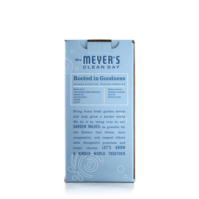 A blue and brown cardboard box labeled Mrs. Meyers Foaming Hand Wash Concentrate Starter Set stands upright against a white background, featuring the slogan Rooted in Goodness and highlighting garden-inspired scents, eco-friendly values, and natural cleaning agents like essential oils.