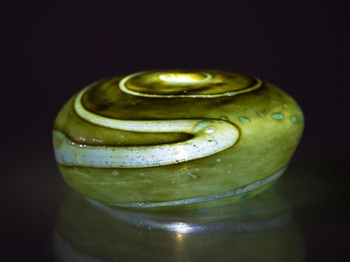 Forest green votive memorial stone with white swirls and a hollow interior for LED tealight.