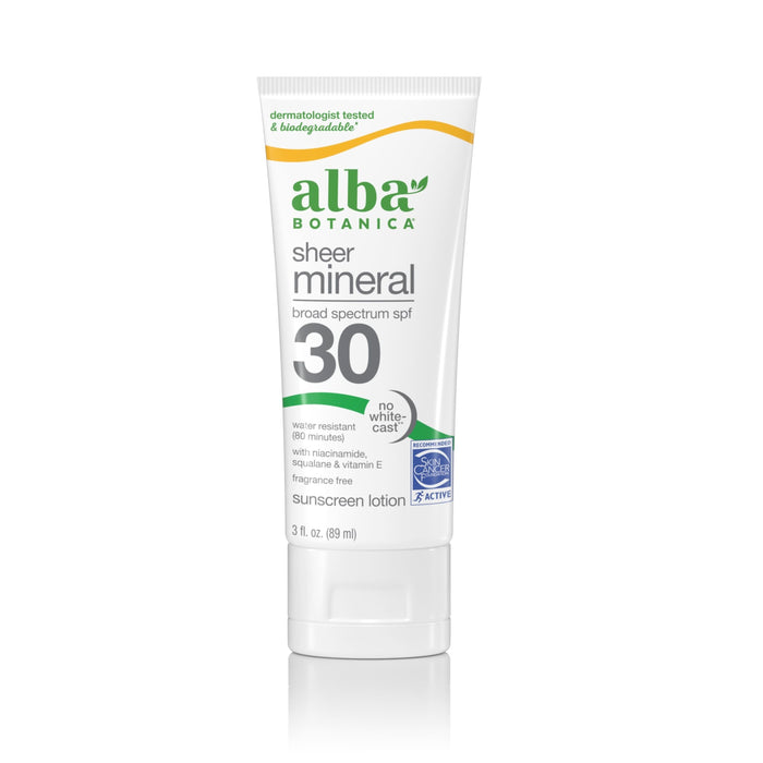 A white tube of Alba Botanica Fragrance Free Sheer Mineral SPF 50 sunscreen features green and orange accents, broad-spectrum protection, water resistance, fragrance-free labeling, and niacinamide.