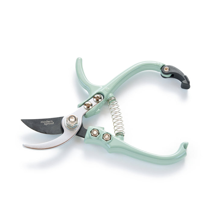 Modern Sprouts mint green Garden Pruners feature a sharp, silver bypass blade with a black tip. Crafted from durable carbon steel with a visible spring mechanism, they have two sturdy handles, all elegantly displayed against a plain white background.