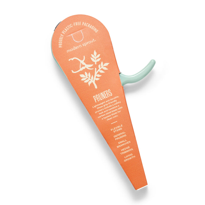 The Garden Pruners by Modern Sprout come in plastic-free packaging with a cardboard cover showcasing plant branch illustrations. Features include flexibility, carbon steel blades, and three cutting options for healthy growth.