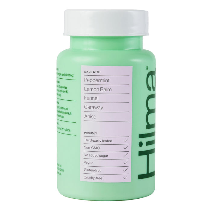Hilmas green bottle of Gas + Bloat Relief displays a side label with herbal ingredients: peppermint, lemon balm, fennel, caraway, and anise. Its third-party tested, non-GMO, vegan, gluten-free, sugar-free, and cruelty-free—ideal for soothing the digestive tract.