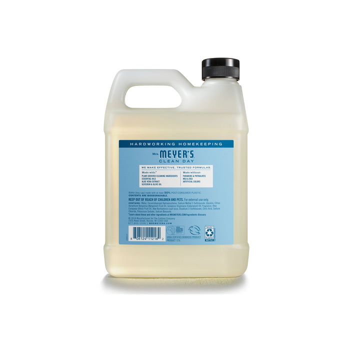 A clear plastic jug with a black cap contains Mrs. Meyer’s Gel Hand Soap Refill, made with essential oils. The back label displays product information and instructions in blue and white.