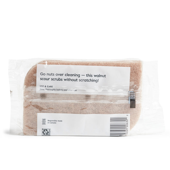 Grove Co.s Walnut Scouring Pads offer non-abrasive cleaning with a label that says, Go nuts over cleaning — this walnut scour scrubs without scratching! The see-through package reveals the scrub and includes care instructions, emphasizing responsible Canadian manufacturing.