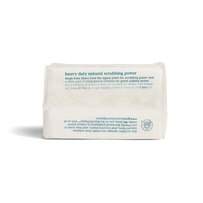 A Grove Co. Walnut Scrubber Sponge, rectangular and white with natural plant-based cellulose and agave fibers, is shown in clear packaging with blue text highlighting its heavy-duty cleaning power on a white background.