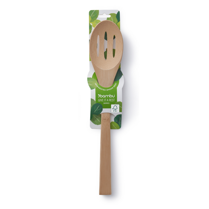 The 'Give It a Rest' Bamboo Slotted Spoon by Bambu features a long handle and FSC-certified bamboo, displayed on green and white leaf-patterned packaging with the Bambu brand name.