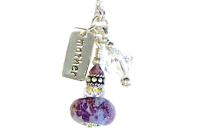 Handmade glass bead charm necklace with a purple infused bead, crystal accents and a silver tag engraved mom
