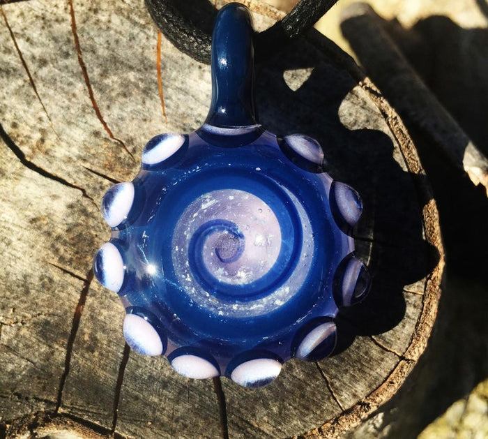Blue glass bubble keepsake pendant with ash swirl and white edge dots, shown from another angle.