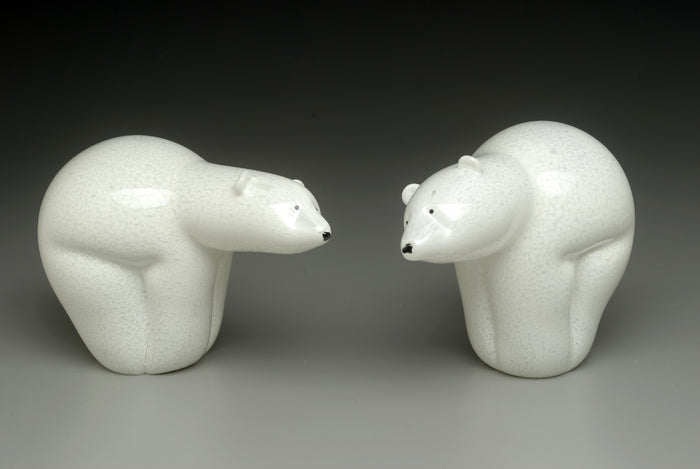 Two white ceramic polar bears facing each other as a cremation ash keepsake sculpture