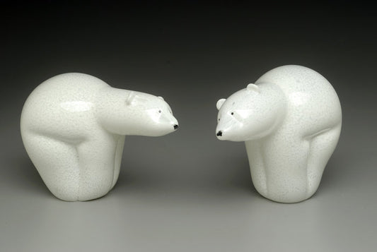 Two white ceramic polar bears facing each other as a cremation ash keepsake sculpture