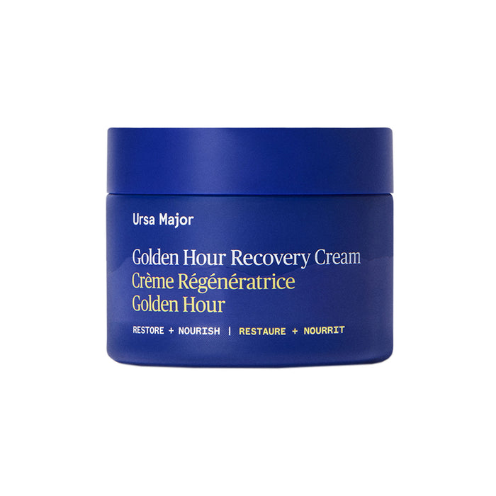A blue jar labeled Ursa Major Golden Hour Recovery Cream (English/French) with "Restore • Nourish" and "Restaurer • Nourrir" at the bottom, this face cream deeply hydrates for radiant skin.