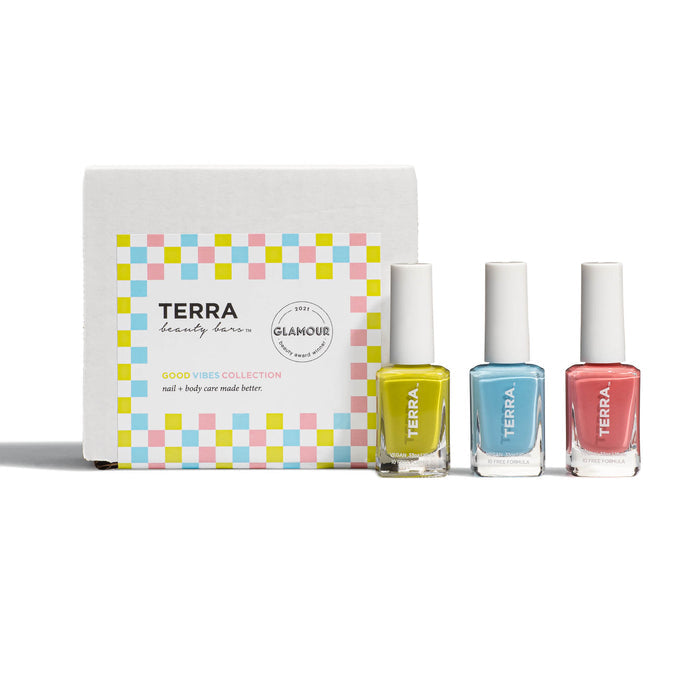 The Good Vibes Kit by Terra Beauty Bars features three bottles of salon-quality, vegan nail polish in bright yellow, blue, and pink hues within a box adorned with a colorful checkered design.