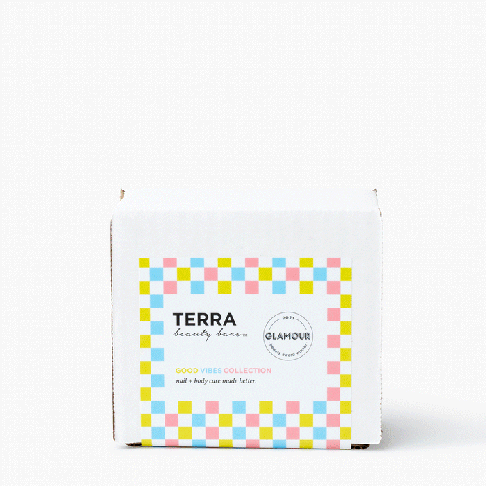 A white box with a vibrant label of pink, blue, and yellow squares reads Terra Beauty Bars Good Vibes Kit, part of the Good Vibes Collection. Its a salon-quality line applauded by Glamours 2021 Beauty Awards for outstanding nail and body care.