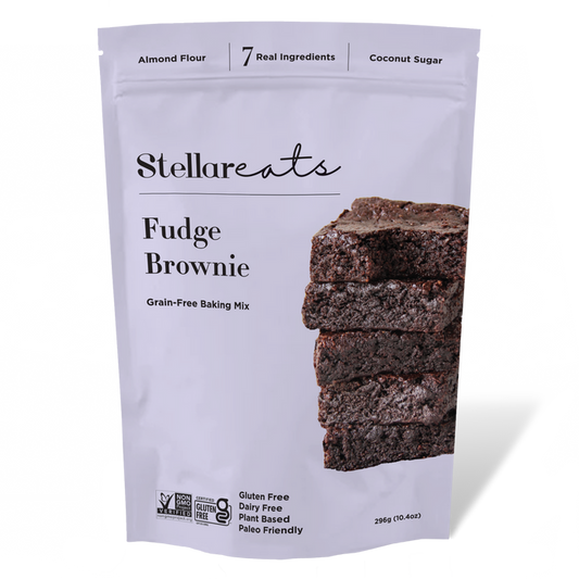 Stellar Eats Grain-Free Fudge Brownie Mix comes in a sleek white bag, highlighting its gluten-free, dairy-free, plant-based, paleo-friendly qualities. Made with almond flour and coconut sugar, it promises the perfect brownie experience.