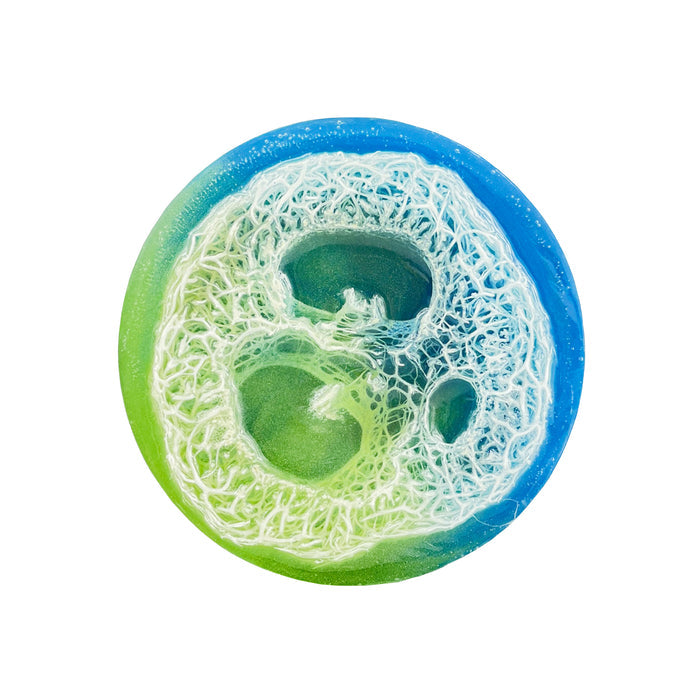 Introducing Soapymanias Magical Island Loofah, an eco-friendly circular soap with a stunning green-to-blue gradient. Featuring a visible fibrous loofah, its design provides a vegan touch of nature with every wash.