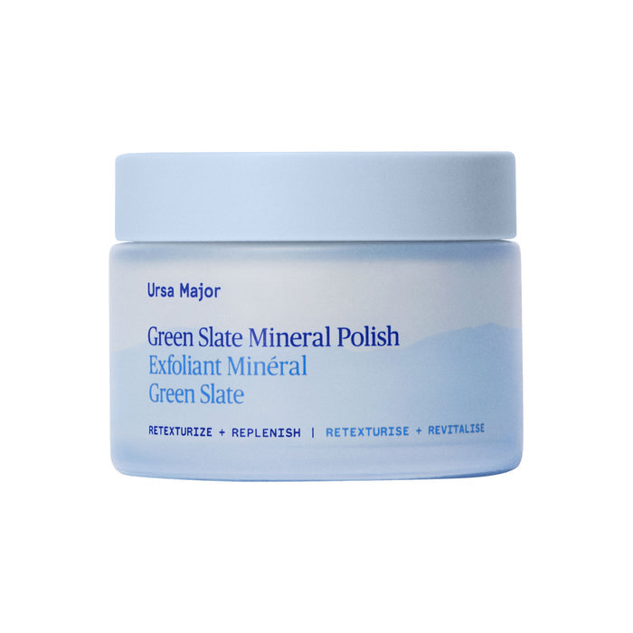A light blue jar of Ursa Majors Green Slate Mineral Polish, featuring blue text and a minimalist design, rests on a white background. This face polish is rich in minerals and uses natural exfoliants.