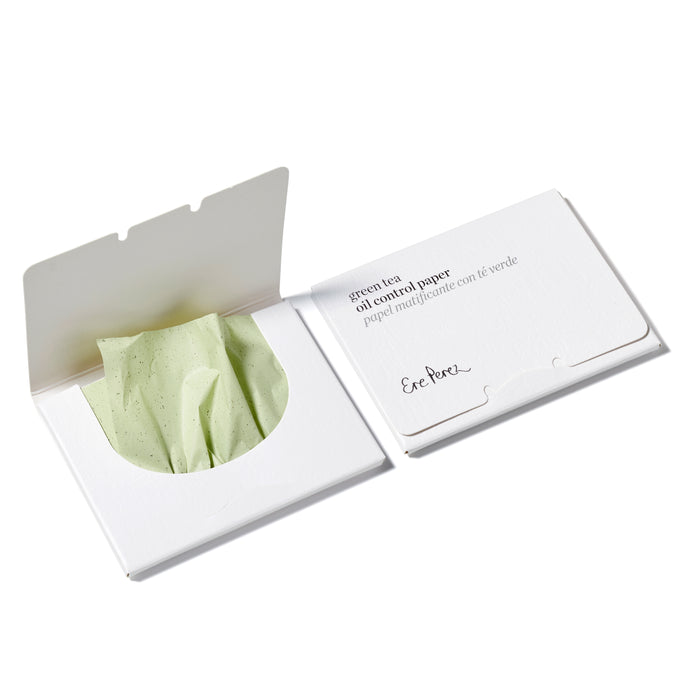 Open and closed packets of Ere Perez Green Tea Oil Control Papers enriched with anti-inflammatory green tea extract. The open packet shows light green sheets made from hemp pulp partially pulled out, housed in minimal packaging with simple text on a white background.