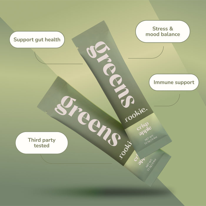 Two green sachets labeled Rookie Wellness Greens + Superfood float on a soft green background. Text highlights daily benefits: probiotics for gut health, stress and mood support, immune boost, and third-party testing.