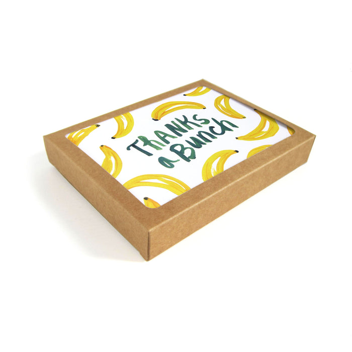 A brown, recyclable cardboard box from The Neighborgoods Greeting Cards includes a charming thank you card featuring the text Thanks a Bunch, with original banana illustrations.