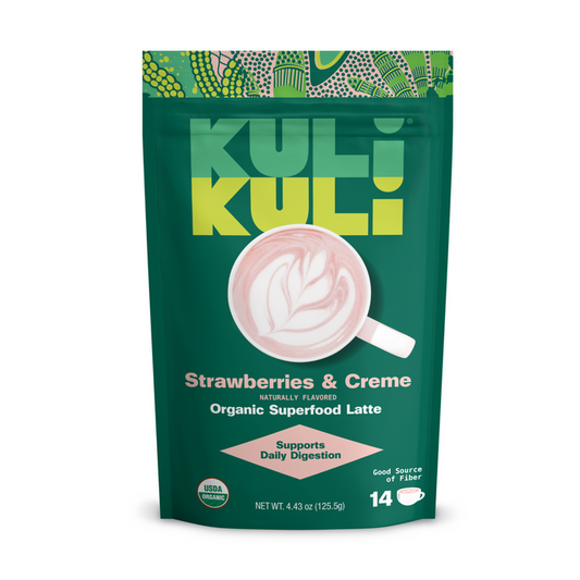A green Kuli Kuli Foods pouch labeled Gut Health Organic Superfood Latte features a fiber-rich blend for digestion, displays a pink and white latte, highlights climate-smart plants, and contains 14 servings.