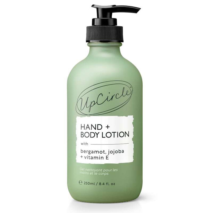 The UpCircle Hand + Body Lotion with Bergamot Water is a 250ml green bottle featuring a black pump, ideal for vegans. Enriched with bergamot, jojoba, and vitamin E, it provides a citrus-scented skincare experience.