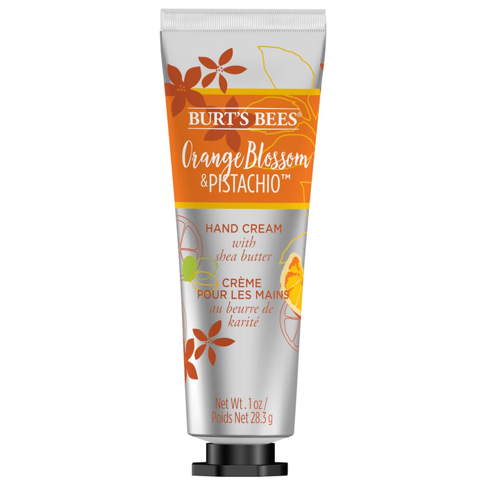 Burts Bees Hand Cream with Shea Butter Orange Blossom & Pistachio is available in a 1 oz (28.3 g) tube. The packaging features orange and pistachio illustrations on a white and orange background, enhancing the essence of this nourishing hand lotion.