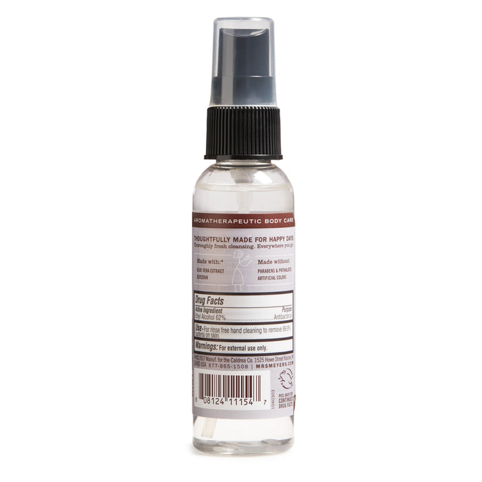 This clear liquid spray bottle has a black pump and cap, featuring a label with text, warnings, ingredients, and usage instructions. As part of Mrs. Meyers aromatherapeutic body care line, this Hand Sanitizer contains 62% ethyl alcohol for sanitizing hands.