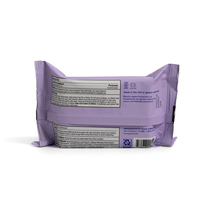 A lavender Grove Co. Hand Sanitizing Wipes VIP pack is shown from the back, displaying 65% alcohol, moisturizing aloe, usage directions, manufacturing info, and Kills 99.9% of Germs in black and gray text.