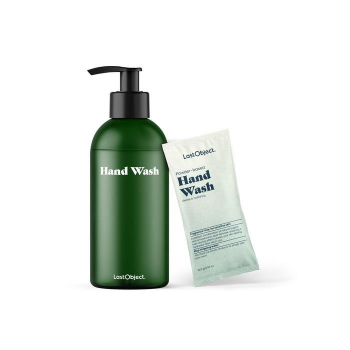 In a simple white setting, a green pump bottle labeled Hand Wash stands next to a light blue sachet of Powder Based Hand Wash from the LastObject Hand Wash Starter Set. Ideal for sensitive skin, these products use natural sugars for gentle cleansing.