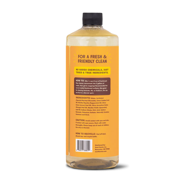 Back of Aunt Fannies yellow Hardwood Floor Cleaner bottle showcases cleaning instructions, ingredients, and recycling info. Features FOR A FRESH & FRIENDLY CLEAN with non-toxic essential oils. Gentle on surfaces, made in the USA without harsh chemicals.