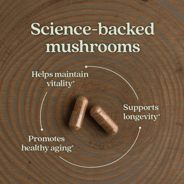 Two brown capsules on a wooden surface, with text around them reading: "Science-backed mushrooms," "Helps maintain vitality," "Supports longevity," and "Promotes healthy aging." White curved arrows connect the phrases.