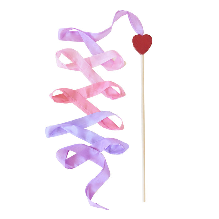 The Heart Streamer from Sarahs Silks features a wooden stick with a red heart on top, adorned with artistic pink and purple streamers. Its perfect for pretend play, enhancing creativity and gross motor skills as the ribbons cascade diagonally on the white background.