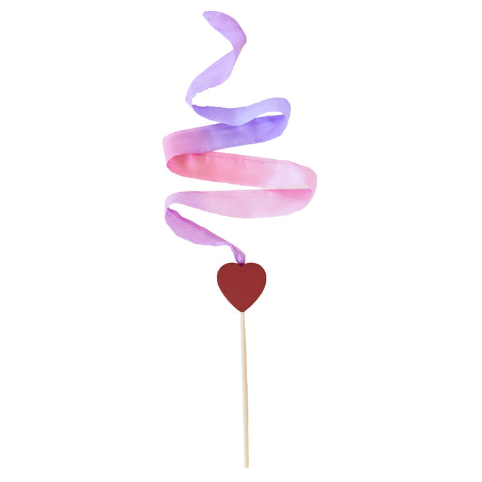 The Heart Streamer by Sarahs Silks features a red heart-shaped cutout on a stick, adorned with pink and purple silk streamers creating a whimsical spiral pattern against a plain white background.