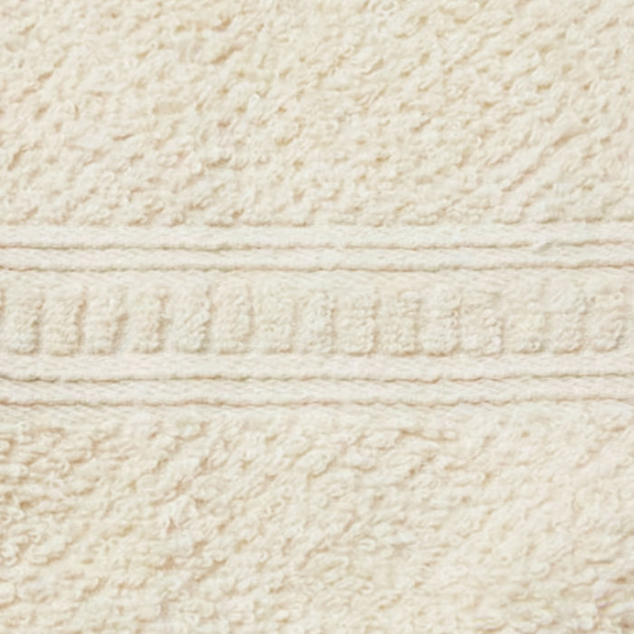 A close-up of Anacts Hemp and Organic Cotton Hand Towel in beige highlights its dye-free, textured weave and a soft, plush appearance. It features a horizontal band with a subtle geometric pattern and slightly raised design crafted from organic materials.