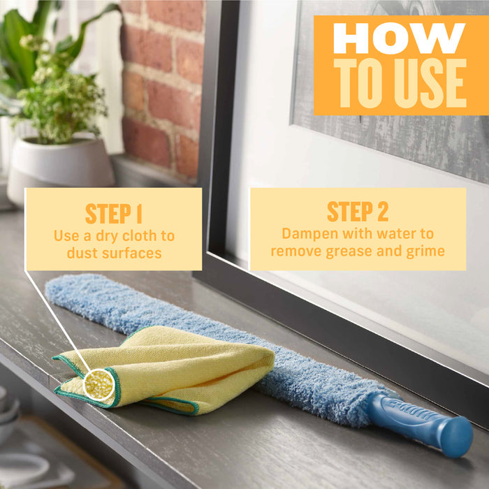 An E-Cloth cleaning tool featuring a blue handle and dual-sided microfiber cloth is displayed next to yellow High Performance Dusting Cloths against a backdrop of plants and bricks. Overlay text: Step 1: Use dry for dusting. Step 2: Dampen to tackle grease and grime.