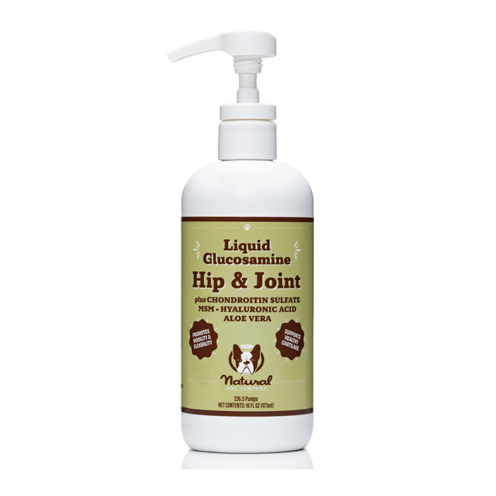 A white pump bottle from Natural Dog Company is labeled Hip & Joint Oil for pets, containing chondroitin sulfate, MSM, hyaluronic acid, and aloe vera. The label features dog and cat silhouettes highlighting its natural benefits for canine joint support.